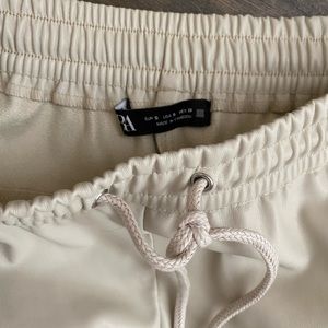 Beige faux leather joggers from Zara
